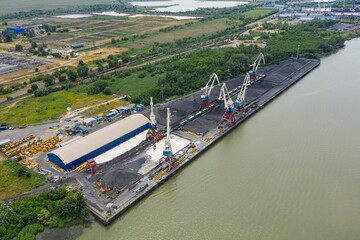 Naklejka premium Marine cranes at the pier ready for loading bulk cargo. Aerial view.