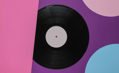 Retro vinyl record on colored background with blue pink circles. Retro minimalism. Top view