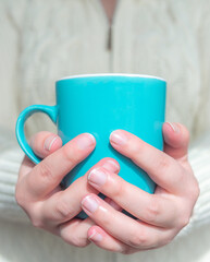 Woman's Hands Holding A mug, Between Her Hands.