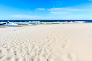 Fototapeta na wymiar Beautiful white sand beach and blue sea near Kolobrzeg, Baltic Sea coast, Poland