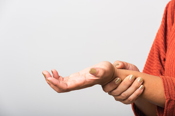 Close up hand of Asian woman she holding her acute pain in wrist of hands, studio shot isolated on white background, Healthcare medicine arthritis body care symptomatic office syndrome concept