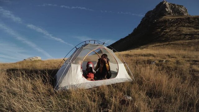 People inside the tent. on a mountainside in Montenegro mooving camera
