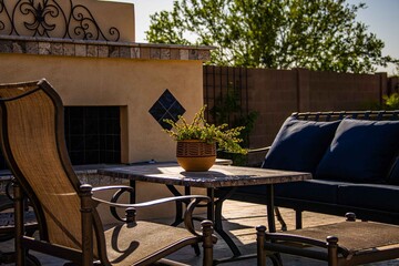 A travertine tile pool deck with plants and lounge chairs in the Arizona southwest .
