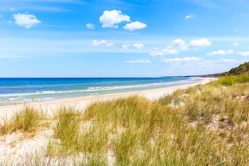 Fototapeta na wymiar Beautiful white sand beach with dunes and blue sea near Kolobrzeg, Baltic Sea coast, Poland