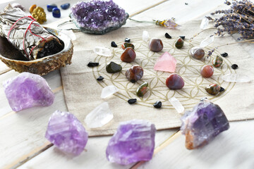 A close up image of a self love crystal grid using the flower of life sacred geometry grid cloth...