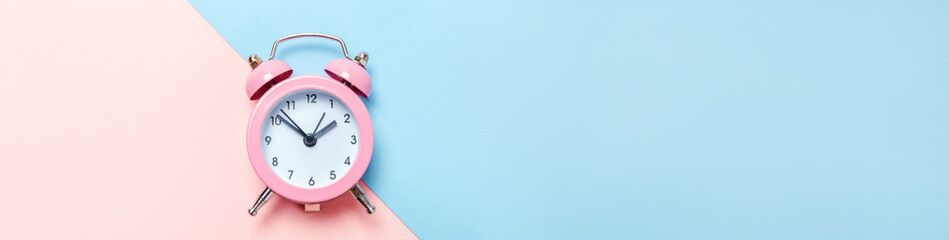 Simply minimal design ringing twin bell classic alarm clock Isolated on blue pink pastel...