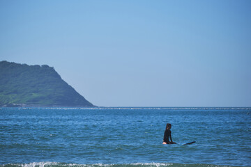 Asian girl doing surfing