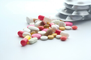 colorful pills spilling on white background, close up 