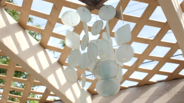 White wind chimes blowing in the wind.