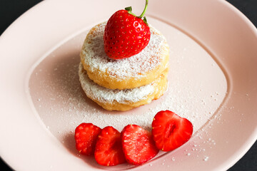 Ukrainian Cuisine Syrniki With Powdered Sugar And Strawberry Close-Up In A Plate. Horizontal