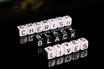 Cherish black lives text on a black background. BLM in support of African Americans people