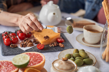 Couple eating tasty breakfast with hot drink
