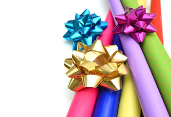 Rolls of colorful wrapping paper on white background