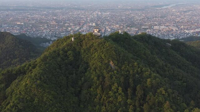 Gifu castle on Mt Kinka, Slow Aerial reveal ancient building and Japanese city