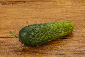 Green ripe fresh cucumber over background