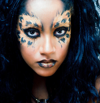 beauty afro girl with cat make up, creative leopard print closeup halloween