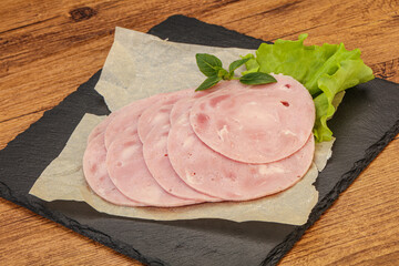 Slised ham snack over board