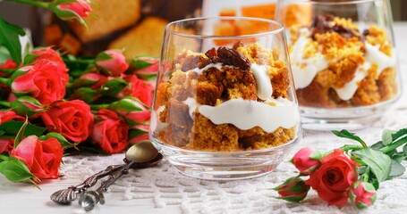 Trifle dessert with caramel, biscuit, cream cheese, whipped cream and raisins. Delicious layered desserts for gourmets. Sweet gift. Selective focus