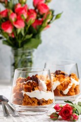 Trifle dessert with caramel, biscuit, cream cheese, whipped cream and raisins. Delicious layered desserts for gourmets. Sweet gift. Selective focus