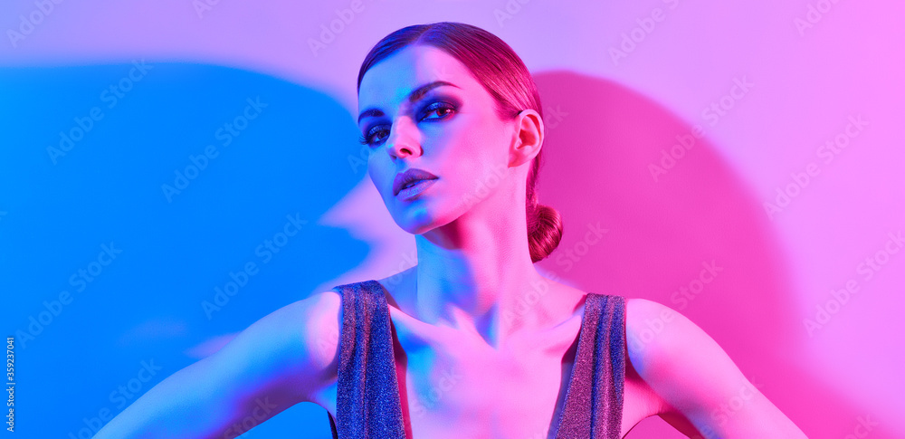 Wall mural high fashion. woman in colorful neon light, make-up. sexy girl, stylish hair, trendy makeup. party d