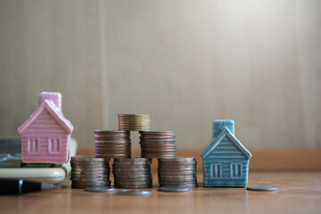 house model set with pile money coins saving for concept investment mortgage fund finance and home...