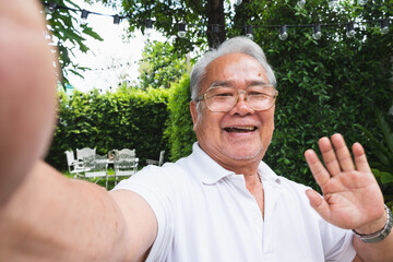 Asian senior man selfie while video call with family