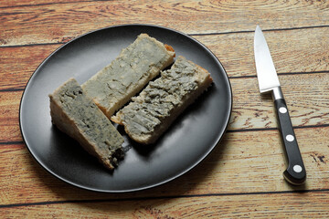 Portion of blue cheese, Cabrales, Picón on a plate with knife
