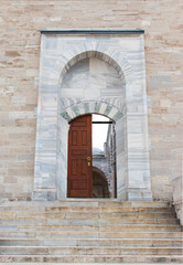 Fatih Mosque. Entrance door of a large mosque made of marble embroidery.