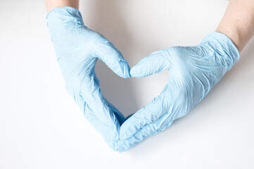 Doctor's hands in medical gloves in shape of heart