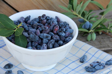 Honeysuckle berries in a vase on the table, honeysuckle, healthy berry, proper nutrition, jam, vegetarianism, ripe berry, sweet berry, blue berry.

