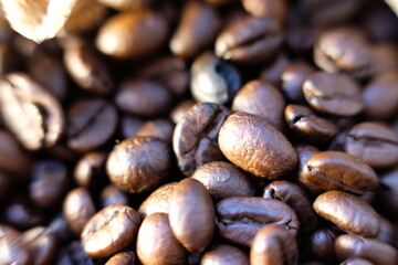 close up coffee beans and coffee cup on wood table background and texture