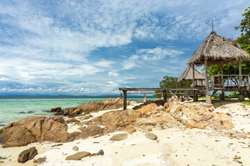Wooden hut with pier on beach, Koh Munnork, Thailand.