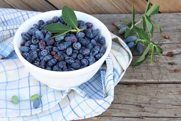 Honeysuckle berries in a vase on the table, honeysuckle, healthy berry, proper nutrition, jam, vegetarianism, ripe berry, sweet berry, blue berry.

