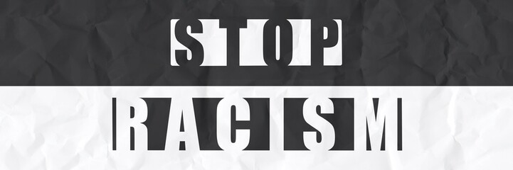 Stop Racism on a black and white crumpled paper background 