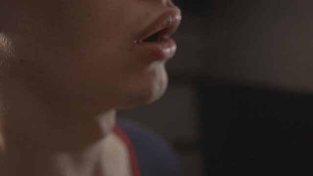 Side View Of A Young Man Vaping With Smoke Coming Out From The Nose And Mouth. - close up