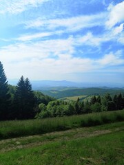 Panoramic view over slovenian hill landscape, sky with clouds, summer