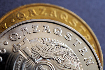 Translation of the inscription: «Kazakhstan». Obverse of Kazakh coins 50 and 100 tenge. Name of the country and national emblem. Transition of the Republic of Kazakhstan to the Latin alphabet. Macro