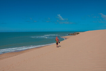 The dunes of Taroa |Man walks over the sand to the beach - Tourism |Punta Gallinas Colombia Travel
