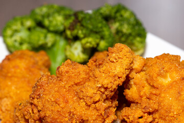 Fried chicken super crispy close up home made bow no brands with broccoli. Tasty and spicy unhealthy food
