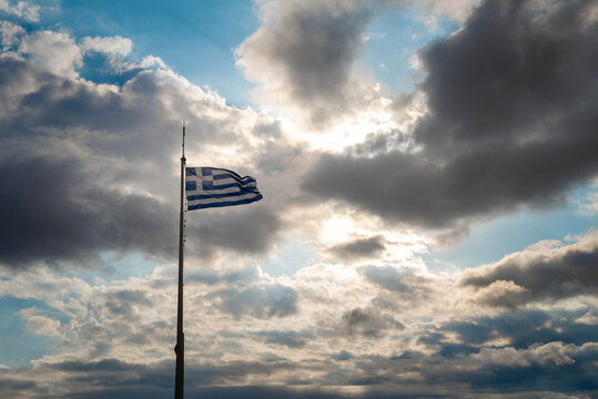 Greek flah on the top of the pole at acropolis, Athens Greece