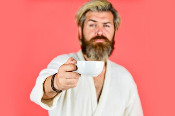 Understanding Your Daily Rhythms. Man with beard in bathrobe enjoy morning coffee. Guy in domestic clothes hold coffee cup. Bearded man with mug. Breakfast concept. Morning begins with coffee