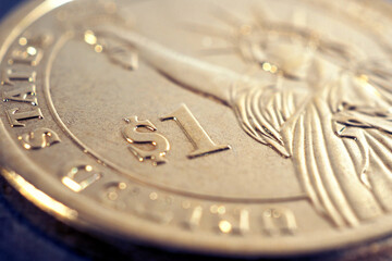 Fragment of an US American 1 one dollar coin. National currency sign symbol close-up. Bright illustration for news on economic, financial or banking topics. Macro
