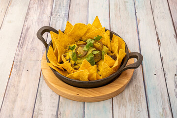 Mexican nachos plate on wooden background
