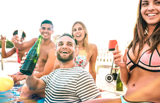 Cropped view of happy friends people drinking white wine champagne at swimming pool party - Vacation concept with young guys and girls having fun in summer day at luxury resort - Warm vintage filter