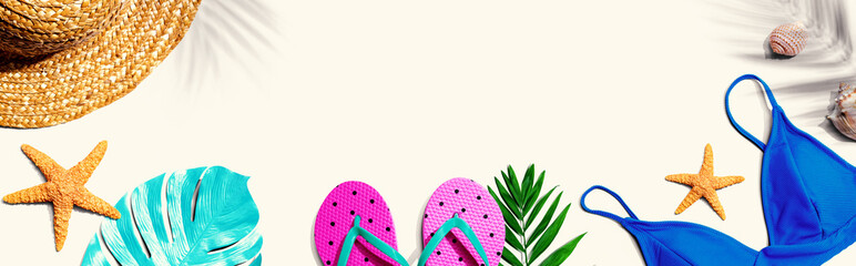 Summer concept with straw hat and swimwear overhead view - flat lay