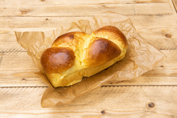 Delicious brioche on wooden table