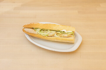 chicken sandwich with lettuce on wooden background