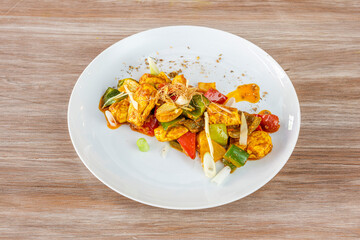 Plate of Murgh Kadhai on wooden background