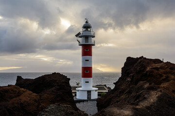 Fototapeta na wymiar lighthouse in the sunset. lighthouse and thunderclouds.