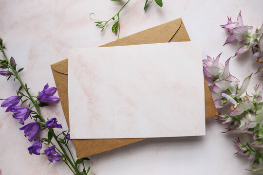 postcard mockup. flower composition. wildflowers on a white background and an envelope. congratulation. invitation. flat lay. place for text
